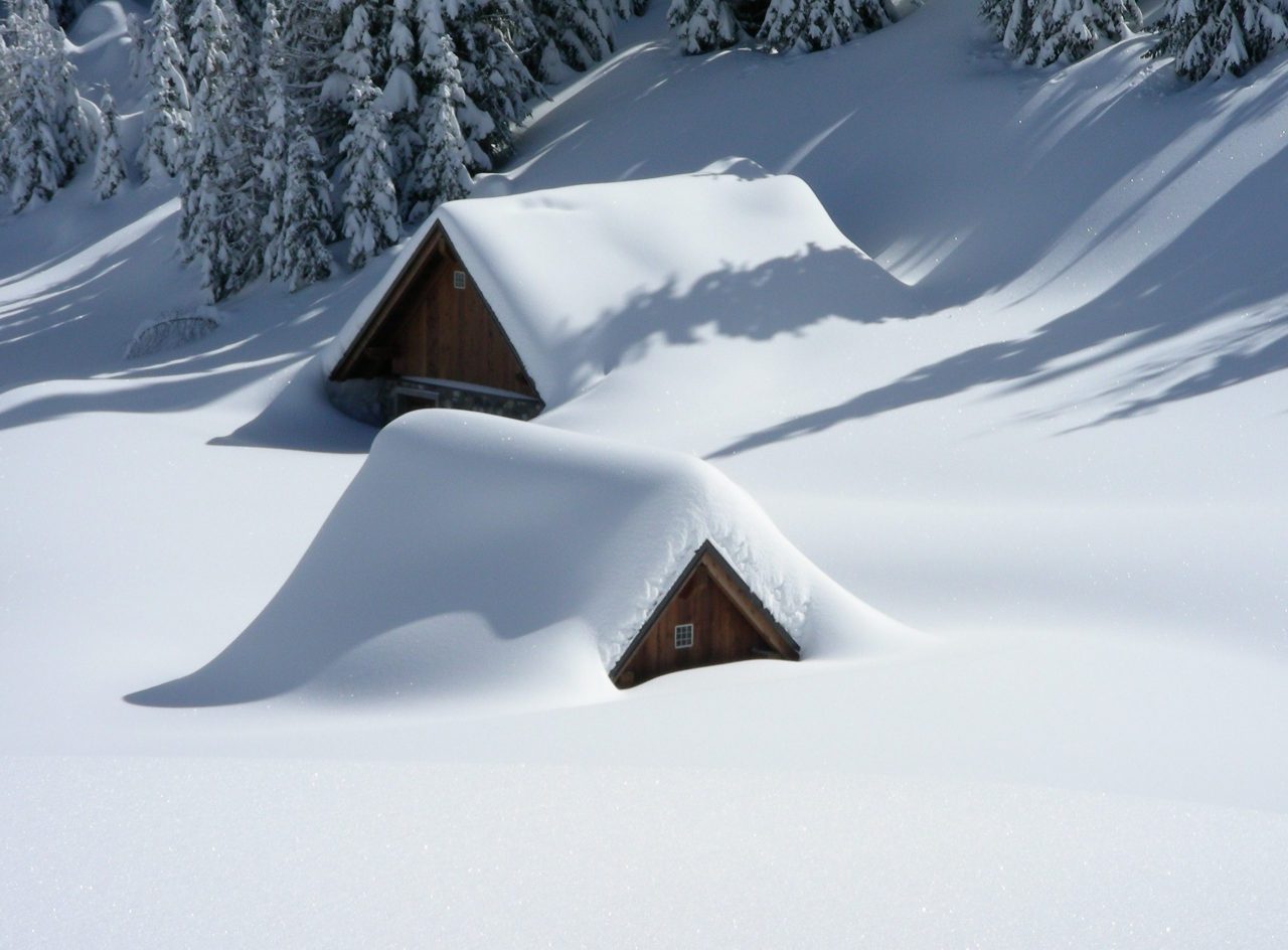 How Snow and Ice Affect Your Roof - Snow-covered cabins