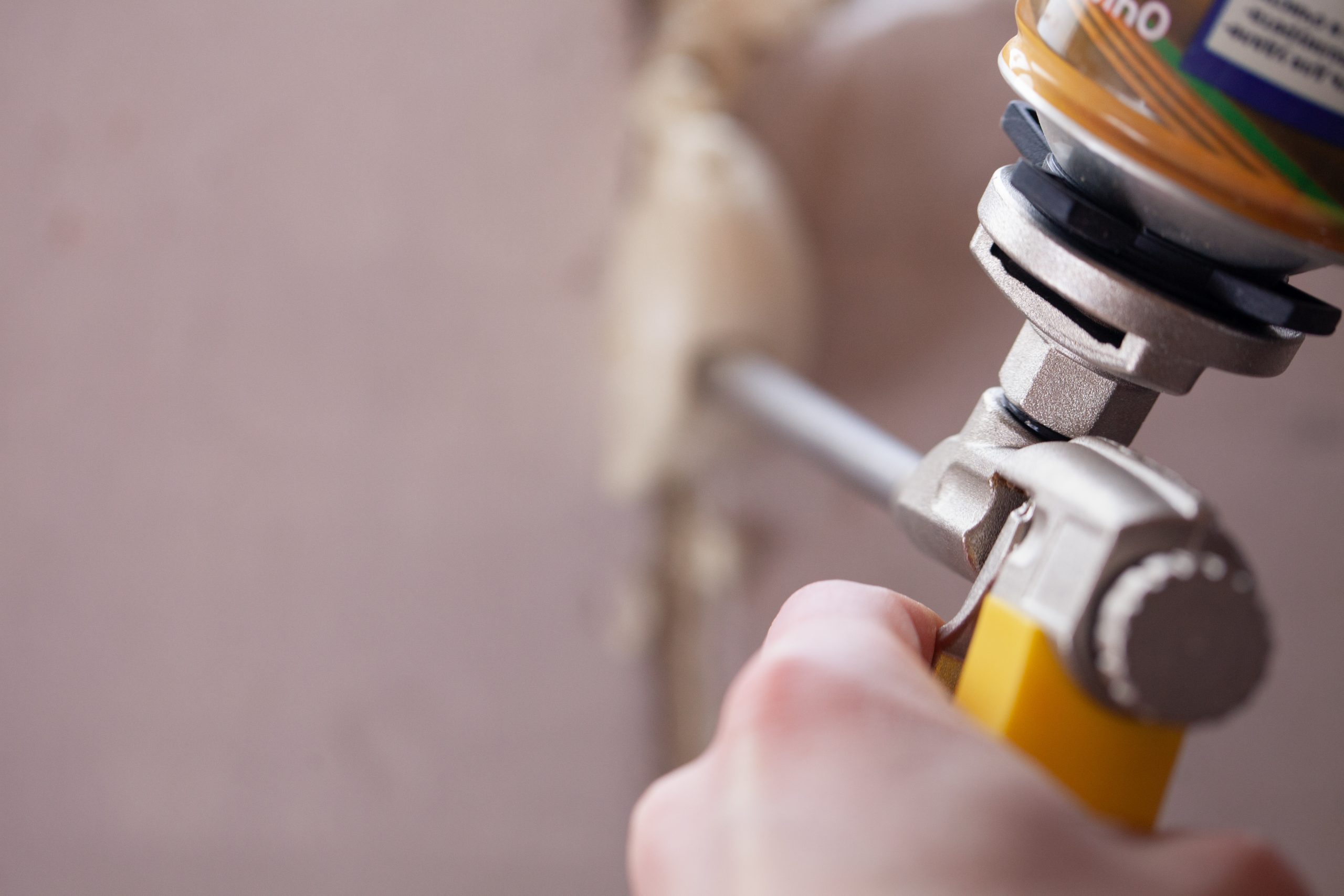 Spray foam roofing maintenance guy holding foam gun applicator