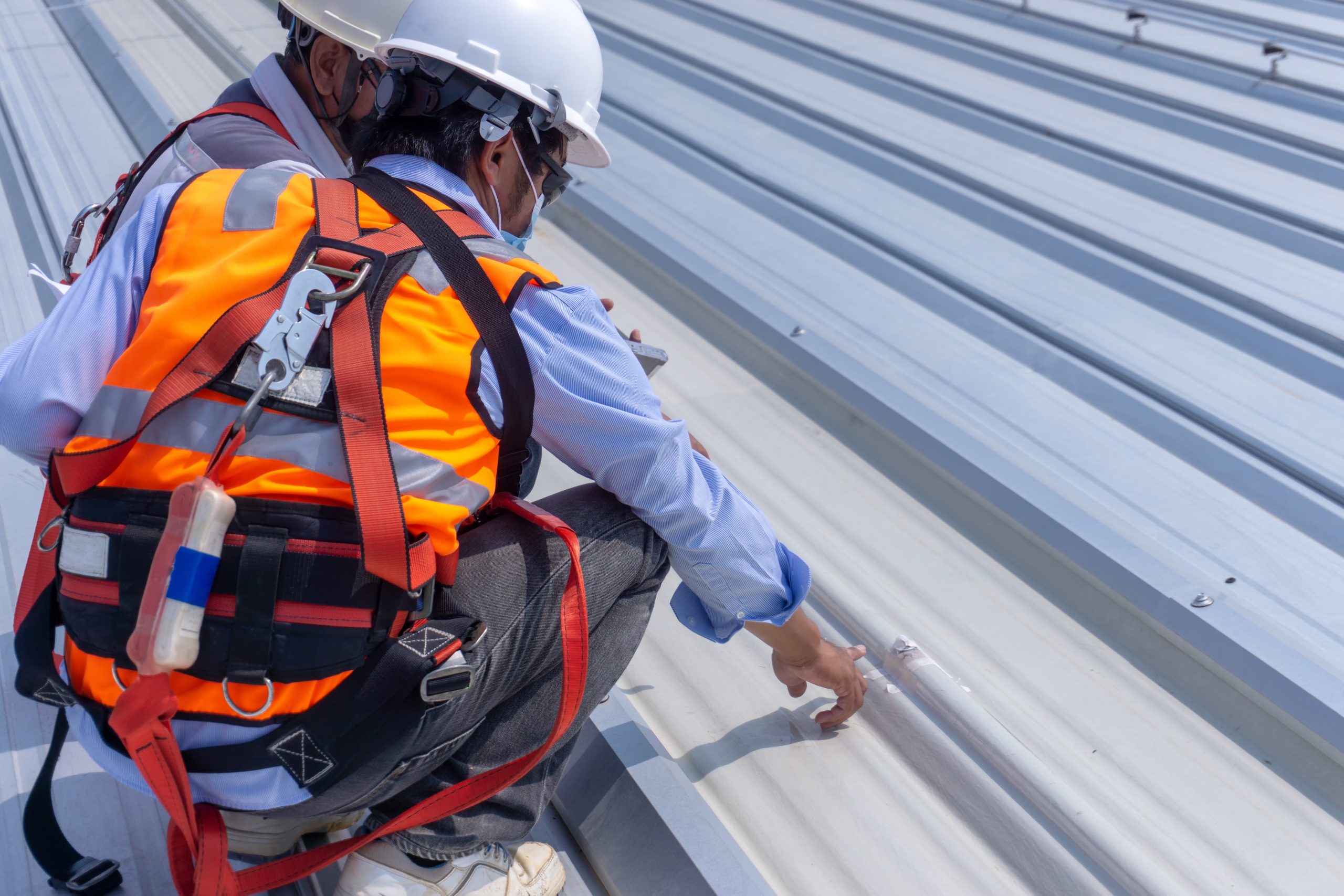 Engineers inspecting a commerical roof leak